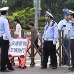 　北京市内で車両の通行を規制する警察官＝１６日（共同）
