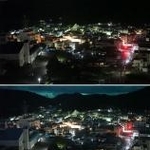　強い光に照らされた高知県土佐清水市＝１９日午後１１時８分（無人定点カメラで撮影）
