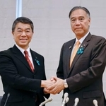 　全国知事会会長の村井嘉浩宮城県知事（左）と握手する、新会長に選ばれた阿部守一長野県知事＝２６日午後、東京都千代田区