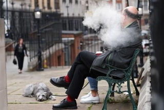 　ロンドンで電子たばこを吸う人＝１日（ロイター＝共同）