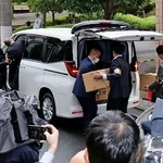 　「退職代行モームリ」の運営会社「アルバトロス」が入るビルから運び出した段ボール箱を車両に積み込む警視庁の捜査員ら＝２２日午前１１時３２分、東京都品川区