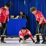 　男子１次Ｌ　ポーランド戦の第３エンド、ショットを放つ臼井。左は柳沢、右は小泉＝ケロウナ（共同）