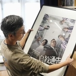 　上映が禁止された映画「自殺通告」のポスターを見つめる監督の周冠威氏＝１７日、香港（共同）