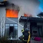 　ロシアの攻撃を受けた家屋の消火活動に当たる救急隊員＝２３日、ウクライナ首都キーウ近郊（ウクライナ非常事態庁提供、ＡＰ＝共同）