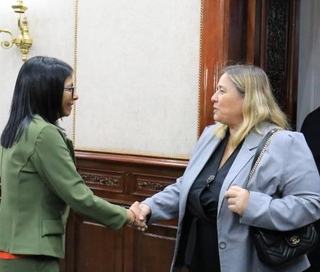 　握手を交わすベネズエラのロドリゲス暫定大統領（左）と欧州連合（ＥＵ）の代表＝１２日、カラカス（ロイター＝共同）