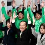 　沖縄県名護市長選で３選を確実にし、万歳する渡具知武豊氏（前列中央）＝２５日夜、名護市