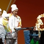 　コルティナダンペッツォで行われたミラノ・コルティナ冬季五輪の聖火リレーに参加したランナーのマヌエラ・アンジェリさん（左）ら＝２６日（共同）