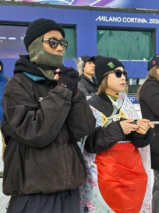 　ミラノ・コルティナ冬季五輪のスノーボード男子スロープスタイルの会場で、手を合わせて見守る長谷川帝勝の父俊介さん（左）＝１８日、イタリア・リビーニョ（共同）