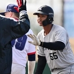 　ＷＢＣチェコ代表との練習試合の５回、安打を放ちコーチとタッチを交わすロッテ・桜井＝都城