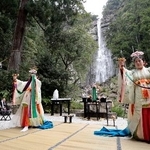 　熊野那智大社の「桜花祭」で舞を披露する巫女。奥は那智の滝＝１４日午前、和歌山県那智勝浦町