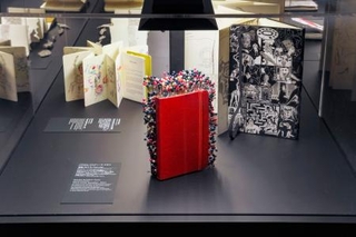 　巡回展「Ｄｅｔｏｕｒ」の展示風景。手前は、ノートにカラフルな装飾を施したパスカル・マルティーヌ・タヨウ「無数（の人々）」（２０１１年）＝東京・六本木（提供写真）