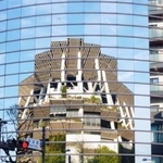 　ＭＵＦＧスタジアム（国立競技場）を映し出すビルのガラス外壁＝東京都渋谷区