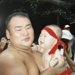 　父の甲山親方（元幕内大碇）に抱っこされる０歳の頃の若碇＝２００５年、京都市の松尾大社