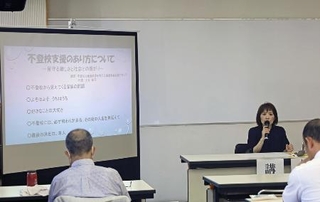 　不登校について講演する「函館アカシヤ」代表の土谷結花さん（右奥）＝２０２４年８月、北海道函館市