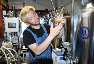 　醸造中のビールの色味を確認する藤城佳央さん＝２０２５年６月、愛知県田原市
