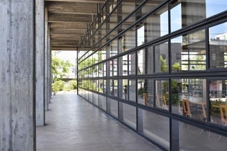 　「旧上野市庁舎ＳＡＫＡＫＵＲＡ　ＢＡＳＥ」に継承されたコンクリートの柱（左）と「水平連続窓」