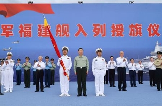 　中国軍の新型空母「福建」が就役し、式典に臨む習近平国家主席（手前中央）＝５日、中国海南省三亜市（新華社＝共同）