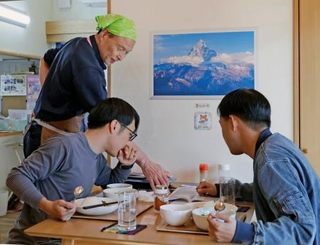 　「ＫａｎａＫａｎａ」を訪れた鈴木奏和さん（右）らと談笑する内海正義さん（奥）＝１１月、宮城県気仙沼市