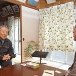 西川征夫さん（左）の話を聞く、明星大の熊本博之教授＝２０２５年１２月、沖縄県名護市