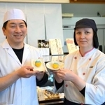 　ウクライナ国旗色の和菓子を持つ谷川イリーナさん（右）と上田浩人さん＝２０２６年３月、福井県小浜市