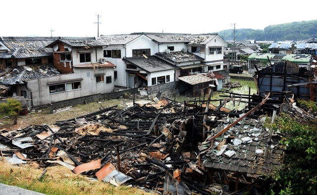 西日本豪雨で川境のアルミ工場が爆発し、爆風で屋根瓦が軒並み落ちた住宅＝１１日午後２時５０分、岡山県総社市下原