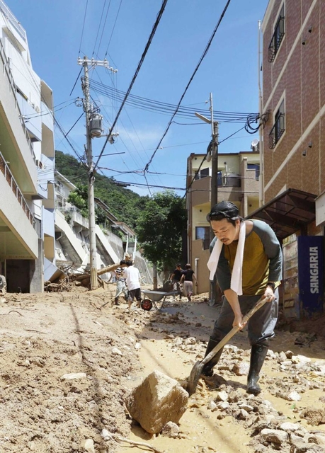 道路に積もった土砂やがれきをスコップでかき出す住民ら＝９日午前１０時３８分、神戸市灘区篠原台（撮影・大森　武）