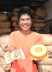「山田錦バウム」を手にする藪西史丈さん＝三木市志染町井上、「稔樹」生産本部