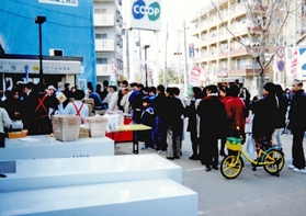 横倒しにした自動販売機をテーブルにし、屋外で営業するコープ武庫之荘＝１９９５年１月１７日、尼崎市（コープこうべ提供）