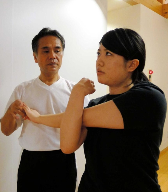前屈や背伸びなど、基本的な体の屈伸で、その人の柔軟性、ゆがみなどを確認する＝芦屋市内