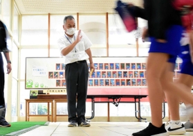 玄関で児童を見送る小山光一校長＝神戸市須磨区堀池町１、東須磨小学校（撮影・中西幸大）