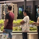 　新築コンドミニアムのショールームで建物の模型を見つめる客＝３月２８日