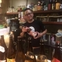 「西屋」のパルオ大将こと原口雅之氏。２０１８年の干支、戌（いぬ）のラベルがついた日本酒と