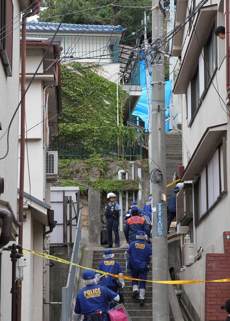 女児の遺体が発見された現場へ向かう捜査員。左上の青瓦の文化住宅が容疑者の自宅＝２４日午前１０時３３分、神戸市長田区長田天神町１