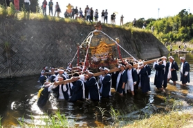 みこしを担いだまま志染川に入っていく担ぎ手たち＝神戸市北区山田町中