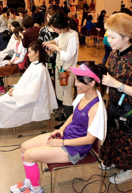 おしゃれランナー賞のブースで、ヘアメーク体験を楽しむ女性ランナーら＝神戸市中央区港島中町６（撮影・小林良多）