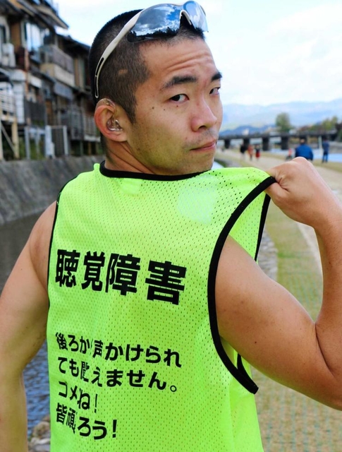 背中に後続のランナーに向けたメッセージが書かれたウエアを着る黒川大樹さん＝１１日午前、京都市