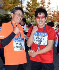 完走し、たたえ合う秋定敦さん（左）と裕人さん＝神戸市中央区港島中町６
