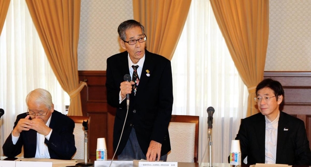 実行委員会総会であいさつする西川公明会長（中央）＝神戸市中央区