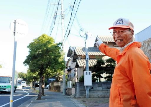 「おらんようになったわ」と笑うスクールガードの金井新太郎さん＝明石市大久保町高丘６