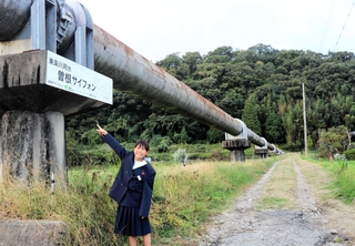 管の中を人々を救った貴重な水が流れる。田畑を潤す水を運ぶ曽根サイフォンと藤原茉陽菜さん＝加東市松沢
