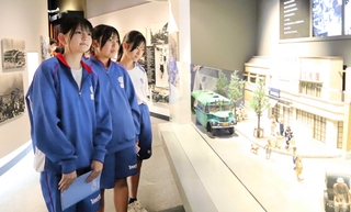 館内の展示を見て回る藤村恋魅さん（左手前）ら山陽中の放送部員＝姫路市西延末、姫路市平和資料館