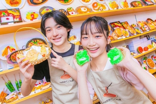 完成した食品サンプルを持つ小沢ちひなさんと浅井陽人さん