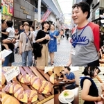 豆腐、串カツ、練り物、パン…など、約２時間かけ、水道筋の商店街・市場をかっ歩し、逸品を食べ歩く「つまみ食いツアー」の様子（撮影・斎藤雅志）