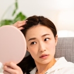 ヘアスタイルをチェックする女性のイメージ（miya227/stock.adobe.com）