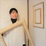 自作の額縁を手に魅力を語る吉田さん