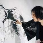 筆を使わない技法で描く荒川さん