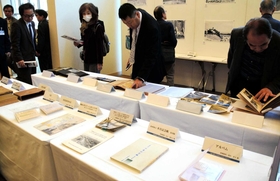イベント会場に展示された資料を手に取る来場者＝神戸市中央区下山手通５（2018年11月24日） 