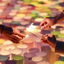 ろうそくの火を分け合う＝１７日午前５時３５分、神戸市中央区加納町６、東遊園地（撮影・鈴木雅之）