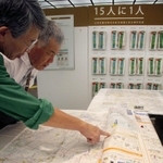 防災士と一緒に地図を見て、自宅周辺の危険箇所や避難経路などを確認できる防災啓発ブース＝さんちか夢広場