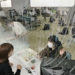 新型コロナウイルスの飛沫（ひまつ）感染を防ぐため、小野市は市役所窓口にビニール製の透明シートを設置。シート下の隙間から市民に書類を渡す＝小野市王子町（撮影・笠原次郎）